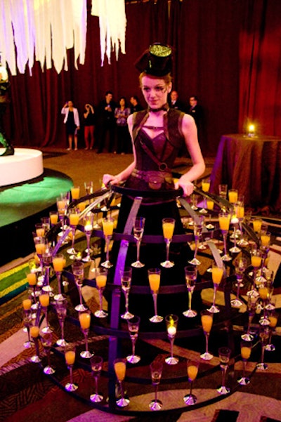 A staffer dressed in a tiered metal skirt that held champagne cocktails roamed the room. Later on, during dessert, her skirt offered guests glasses of champagne-and-gold-leaf gelée with raspberry Bavarian cream and fresh raspberries.
