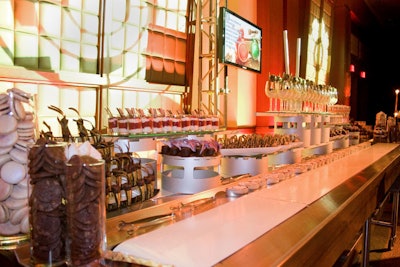 The dessert bar setup included a working conveyor belt, and plasma screens displayed the food station menus.