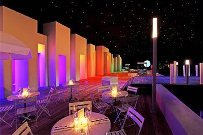 A café setting along the waterfront, placed under a faux starlit sky and moon, provided an area for guests to sit.