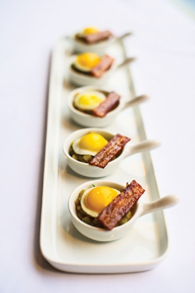 Miniature skillets of Yukon gold hash brown potatoes, sunny-side-up quail eggs, and crispy bacon with house-made sun-dried tomato ketchup, by L-Eat Catering in Toronto