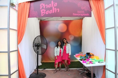 Once inside the venue, bright and colorful signage and lights led guests around the perimeter of the space to different activity booths. Areas included a photo booth, which was complemented by stations where guests could make iPhone cases and T-shirts printed with custom digital artwork.