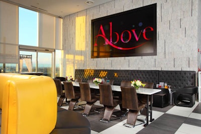 Stone wall with 80-square-foot LED video screen and Calcutta marble table