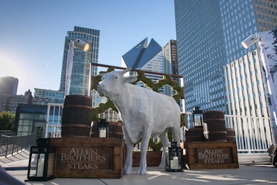 A prop cow stood sentry at the entrance to the meat-centric event.