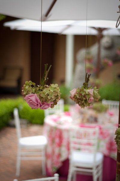 'Bring elegance overhead by dressing up simple white canvas garden umbrellas or ceilings with hanging posies, warm sparkling suspended candles, or old-fashioned bistro lights.'