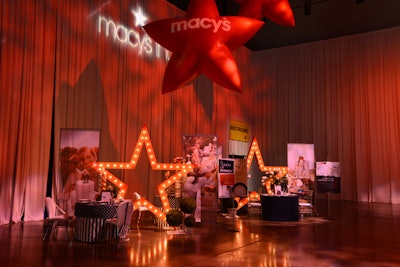 Macy’s set up its signature red balloons and stars at the entrance to the reception, a nod to the marriage equality decor and lighting in the space. The tables displayed the company’s silent auction items.