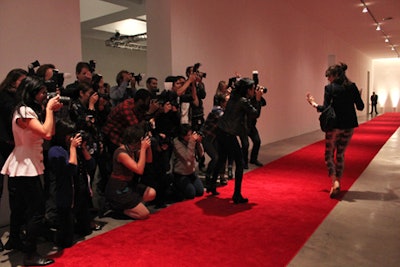 Guests at the Performa benefit in New York in 2011 entered Skylight Soho to find a long red carpet and a swarm of fake paparazzi waiting, but the effect left some feeling more unsettled than glamorous. As guests walked on the carpet, the group of 45 hooting performers with flashing cameras would roar in a moment of arrivals-zone authenticity not seen in regular TV and magazine coverage. Some of the guests ate it up and posed—the artsy crowd had plenty of people clearly dressed to be noticed—while others hurried past to get into the party proper.