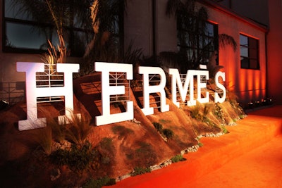 Hermès opened its new Beverly Hills flagship store with a Bounce-produced party so transformative, it almost felt like an entirely other place and time. And that's exactly what the production and design team behind the nuanced bash was going for: “We wanted it to transport you, so when you were walking into the space, you were really taken into another world. We were trying to achieve a sense of disbelief that you would experience while watching a film or a piece of theater,” said Hermès senior vice president of communications Peter Malachi. About 700 guests found a private warehouse in Culver City reimagined with dreamy vintage Hollywood and French flair, the original inspiration for which was drawn from a scarf specially commissioned for the new store. The red carpet arrivals backdrop mimicked the iconic Hollywood hills and sign.