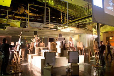 Recreating a life drawing class, artists sketched nude models. Extra easels were set up for guests to create their own sketches.