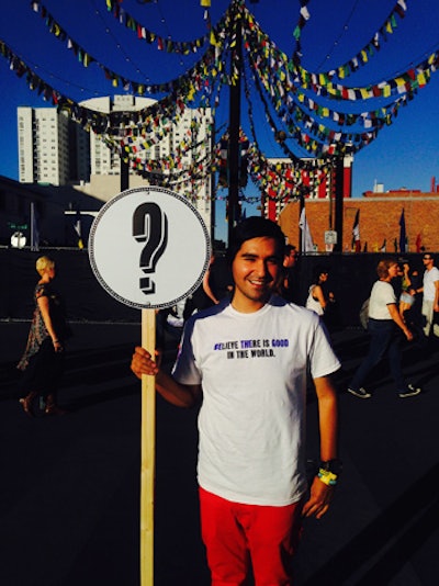 Staffers held signs—readable in any language—to show they were available to answer any questions. It was a useful human-powered directional tool in a festival that spanned 15 city blocks.