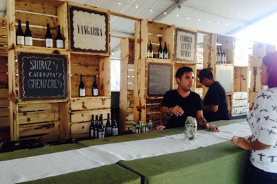 In the so-called 'Alchemy Garden,' wooden crates dotted with wine bottles formed a rustic bar backdrop.