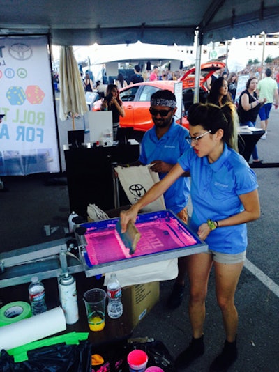 Toyota screen printed logo tote bags with the message 'Life Is Beautiful,' and attendees formed long lines for the swag—among the festival's free perks.