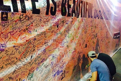 Attendees left their mark on a massive scrawling wall intended as an interactive art piece where people could jot their thoughts or names.