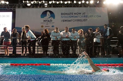 Three large screens set up alongside the pool displayed a variety of Procter & Gamble- and AmeriCares-sponsored commercials related to their efforts in Hurricane Sandy relief.