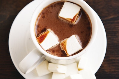 Wolfgang Puck Catering recommends a hot chocolate station, where guests can add items including flavored marshmallows, cherries, malted barley, chocolate shavings, and whipped cream.