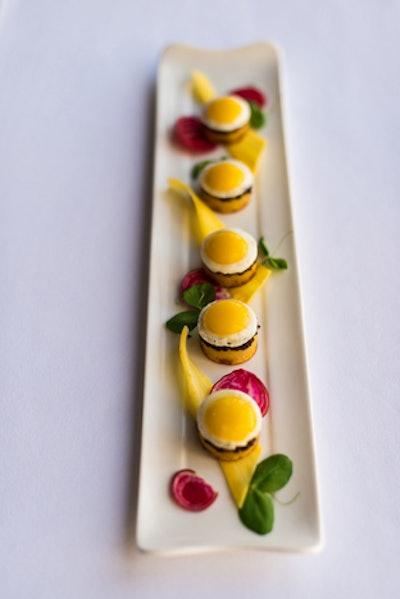 Griddled new potatoes topped with quail eggs, olives, and sun-dried tomatoes, by Oliver & Bonacini Events in Toronto