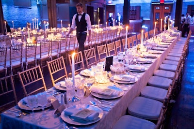 Rather than setting the room with traditional round tables, the organizers created a communal environment for the 280 dinner guests by creating six long rectangular tables inside the venue's main hall.