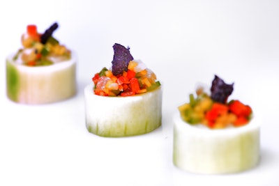 Hollowed English cucumber cups filled with sea bass mango ceviche and blue potato chips, by Esprit Events Kosher Caterers