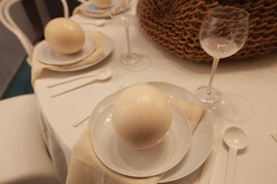Ostrich eggs and plastic utensils decked the table from Premiere Music and Film Systems's table, designed by Jeanne Michaels Interiors. The picnic-like setting was rounded out with wine glasses and a woven basket in the center of the table.