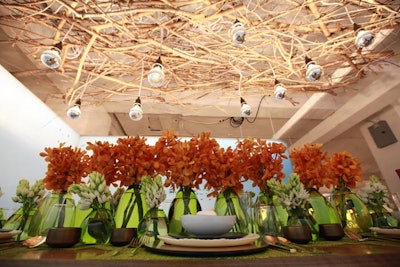 Orange flowers in green bud vases created a simple but lush centerpiece.