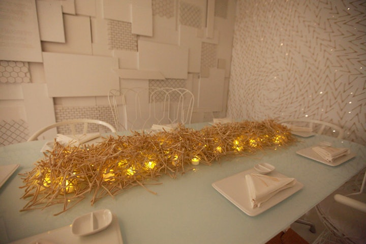 The table's centerpiece was a dense arrangement of wishbones, laid over a row of softly glowing electric candles.