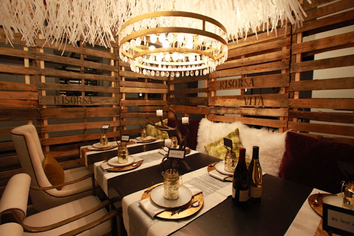 Strips of recycled paper formed a feather-like canopy over the setting designed by Aria Group for Cooperativa Ceramica D'Imola North America.