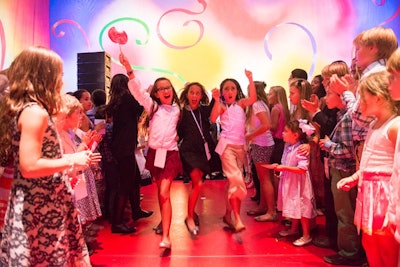 Kids danced down a Soul Train-like aisle as part of a dance party hosted by DJ Uptown Dale.