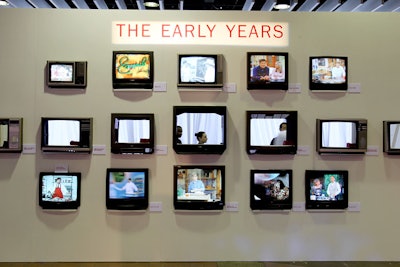 One food station played off the idea that when viewers watch the Food Network, they wish the food could be served directly through their TV sets. Embedded with working televisions playing cooking show clips from the network’s early years, an automat-style wall had chefs handing small plates to guests through a row of televisions with the screens removed.