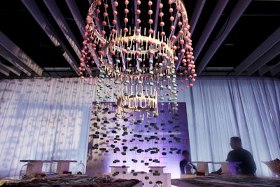Stone Dog Studios crafted dozens of fake macarons from Styrofoam and rigged them to create a 10-foot-tall chandelier that hung over a dessert station serving real macarons in flavors including birthday cake, pumpkin, and pistachio.
