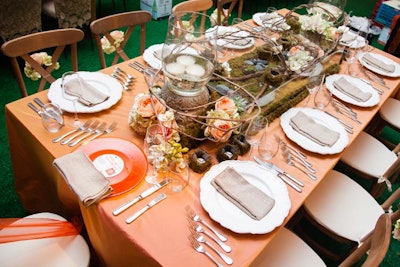 At the table from Designs by Sean, moss served as the centerpiece's foundation. Mini bouquets attached to the chair backs added a sweet touch.