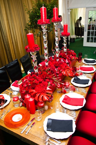 Red roses, carnations, and candles created a holiday mood at the table from Cameron Keating Event Design.