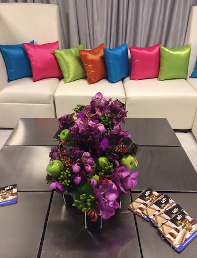Kehoe Designs added jewel-hued pillows and flowers to the sleek rentals from AFR Event Furnishings.
