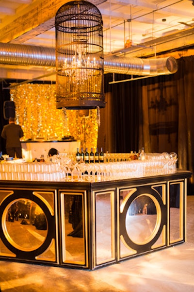 Black and gold accents highlighted another full bar, and a birdcage containing a crystal chandelier hung overhead, adding another on-theme element.