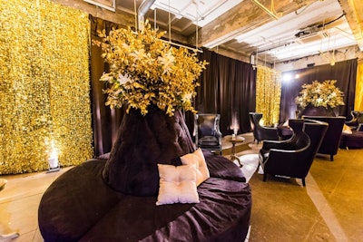 The downstairs space was decorated in tones of gold and black, used to effect in the draped walls. Seating vignettes included chesterfield sofas and black wing chairs.