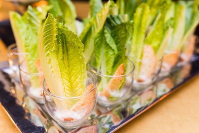 A deconstructed Caesar salad was served by the glass. The stiff romaine leaves mimicked the look of a flapper's feather headdress. Other bites at the event included wasabi deviled eggs, candied bacon, and a 'bees knees' cheese station.