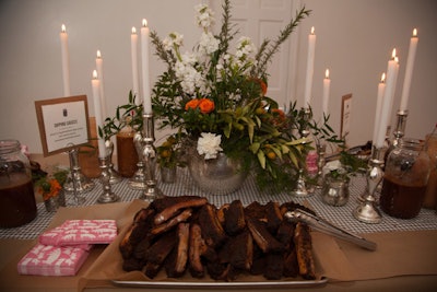 With a floral centerpiece and tall white candles in silver candlesticks, even a room dedicated to barbecue ribs felt festive. Several dipping sauces accompanied the meat, and bones could be discarded in galvanized pails.