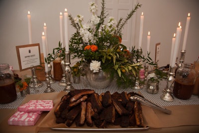 With a floral centerpiece and tall white candles in silver candlesticks, even a room dedicated to barbecue ribs felt festive. Several dipping sauces accompanied the meat, and bones could be discarded in galvanized pails.