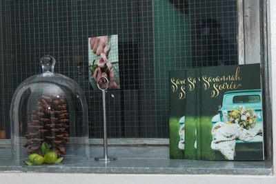 Bell jars of various sizes covered mini tableau including one with two holiday staples: pinecones and citrus fruit.