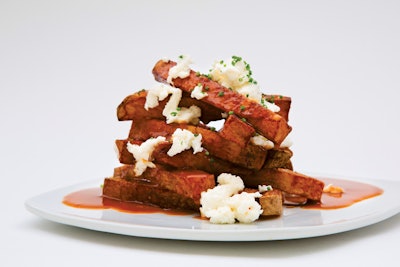 Wolfgang Puck Catering offers a ­poutine station that lets guests top individual plates of French fries with beef or vegetarian gravy and mozzarella or cheddar cheese curds, plus a variety of other toppings including brisket, ham, or duck confit.