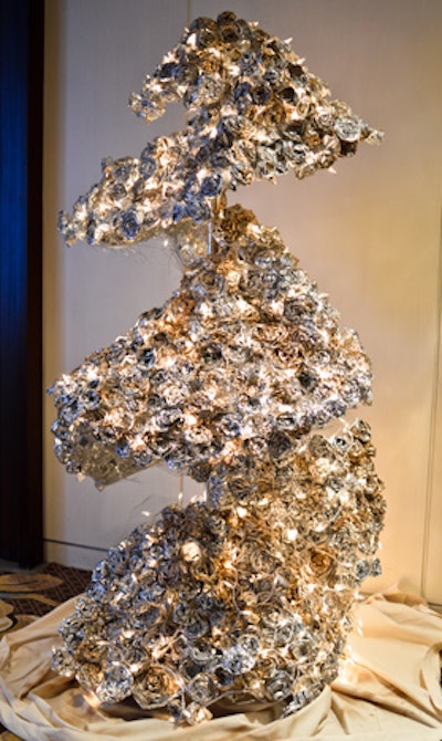 Whitney Osterhout ad Ramzah Khan, graduate students at the Corcoran College of Art and Design, took inspiration from materials frequently used in construction, aluminum tape and chicken wire, to create their 'Metaliicus Rosa' tree.