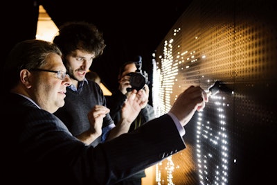 French artist Antonin Fourneau practices water light graffiti, a process that involves using a damp sponge brush to draw on an installation made from thousands of small LED lights that light up when touched by water. Fourneau’s interactive performances are customizable, allowing audience members to try their hand at the art form.