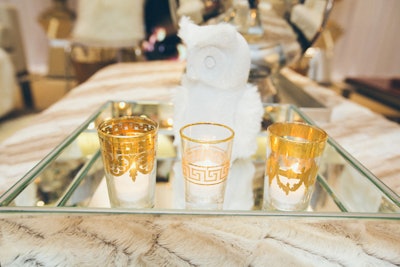 Also in the lounge area, silver trays hold Moroccan tea glasses and winter-white owls as props.
