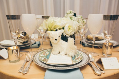 The same winter-white animal motif pops up in place settings. Tables also include gold-rimmed champagne glasses, vintage china, and mercury-glass candle holders (a Debi Lilly signature). BBJ Linen and Tablescapes provided rentals.