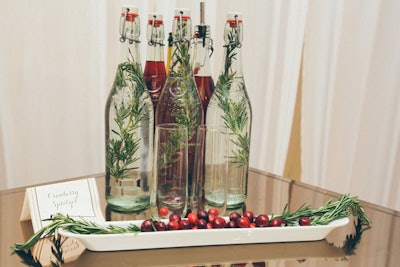 Pure Kitchen Catering prepared champagne-cranberry spritzers and rosemary-infused sparkling water. A white tray of cranberries and rosemary spruced up the drink station—and provided a subtle, holiday-friendly fragrance.