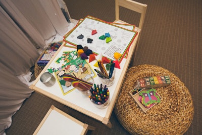 A kids' corner provides a spot for tots to color with Christmas-tree-shaped crayons from the 900 Shops.