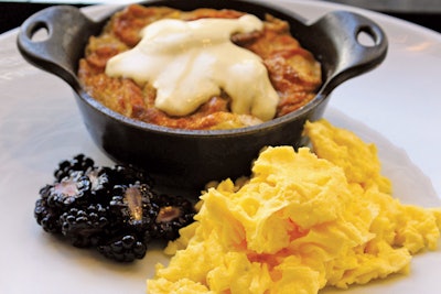 Warm peach bread pudding with scrambled duck eggs and blackberry compote, by the Intercontinental Chicago