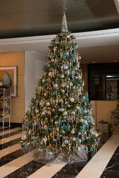 Interior designer Barry Dixon's Venetian Fantasy tree incorporated long strands of clear beads draped around its circumference, Venetian-style glass ornaments, and various shades of blue bulbs.