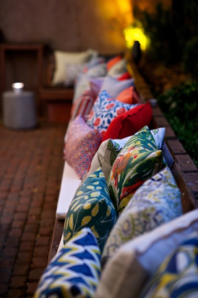 Colorful patterned pillows arranged along a banquette doubled as decor and product display.