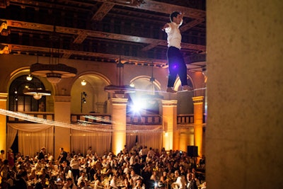 At CyberCoders's Gatsby-theme event, a tightrope walker from Zen Arts hovered 30 feet overhead, surprising guests at dinner and teasing the crowd with leg lifts, wobbles, and the splits.