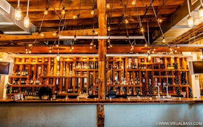 Bar featuring reclaimed 150-year-old wood