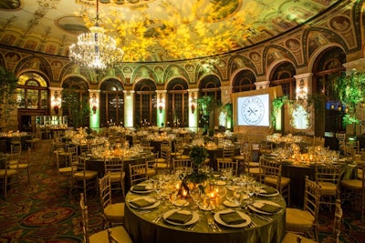 The Breakers hosted the Savannah-theme Saturday night dinner, 'An Evening in the Garden of Good and Evil,' in its Circle Ballroom. It was decorated in a Southern Gothic style with Spanish moss, lanterns, and images of the 'Bird Girl' statue that was pictured on the cover of the book Midnight in the Garden of Good and Evil.